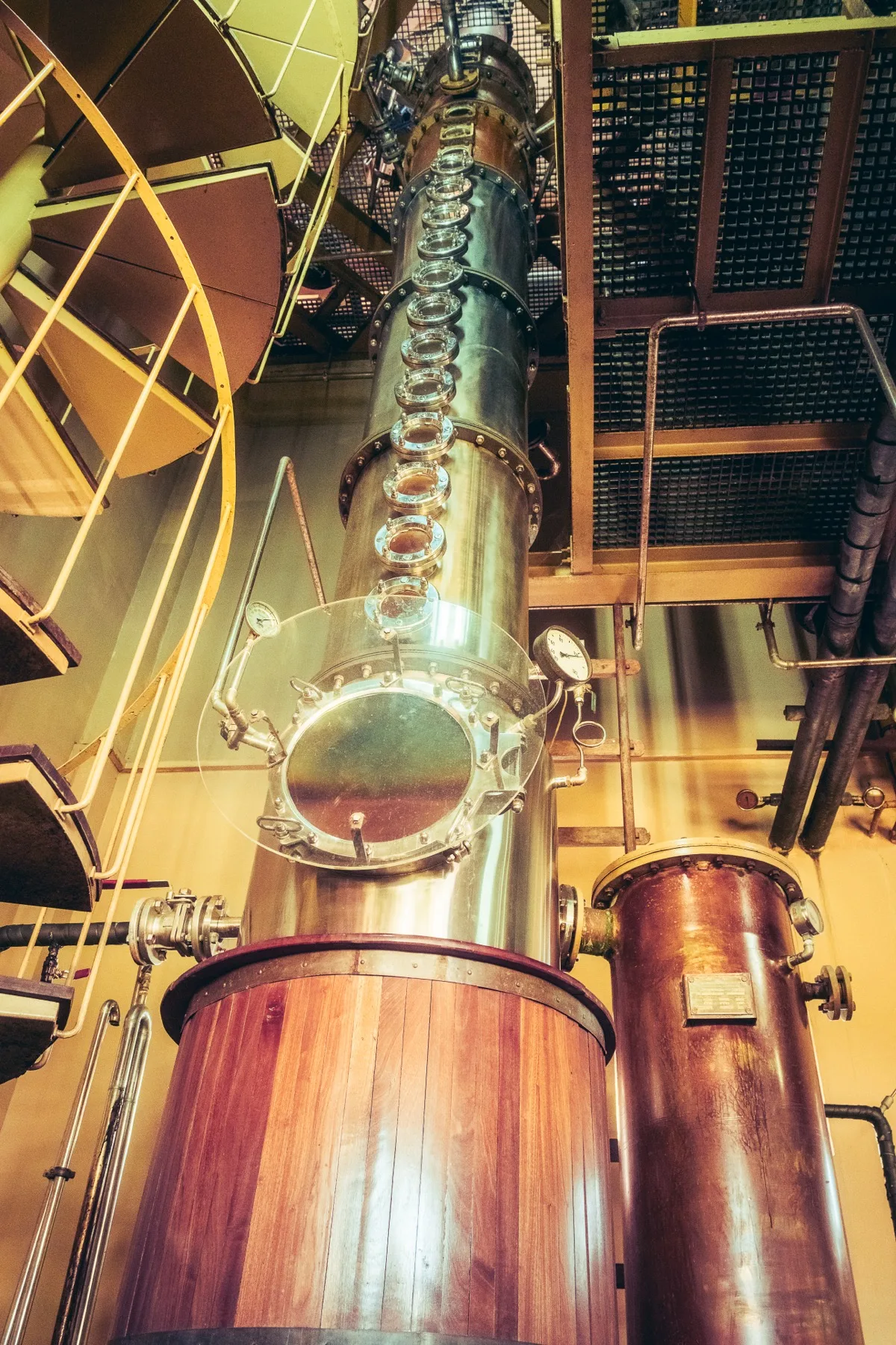 Tall copper column still inside a rum distillery in Mauritius
